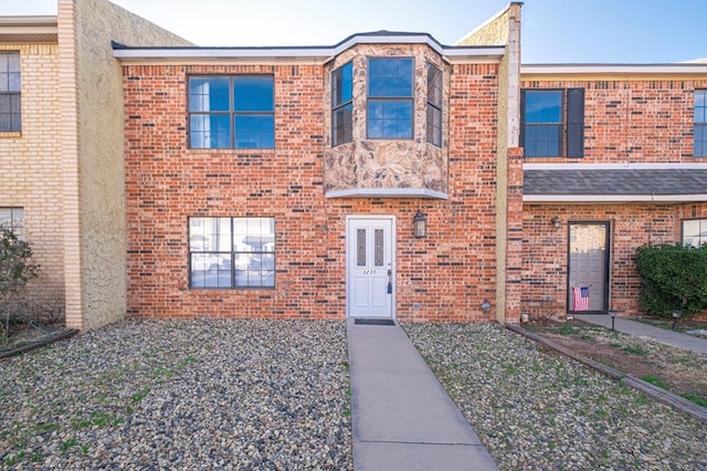 townhome / multi-family property with brick siding