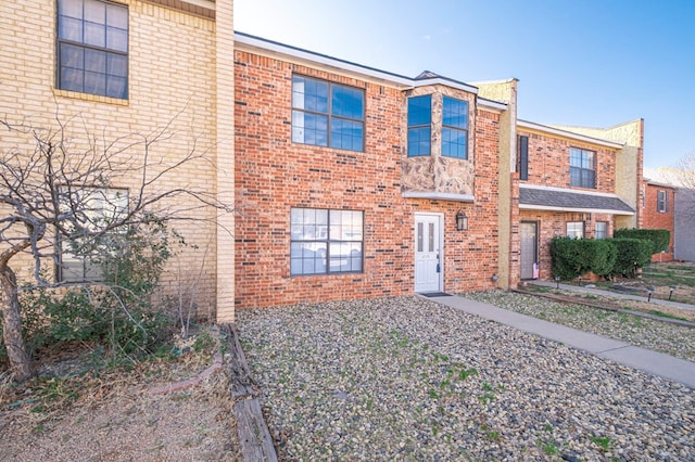 townhome / multi-family property featuring brick siding