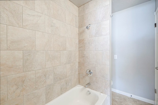 full bath with baseboards and shower / washtub combination