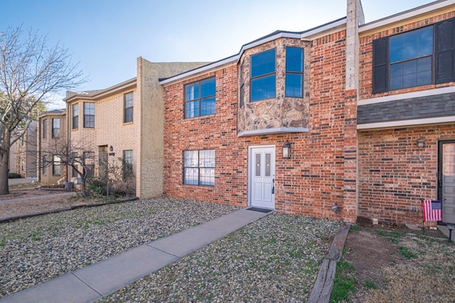 townhome / multi-family property featuring brick siding