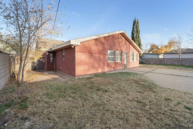 back of house with a lawn