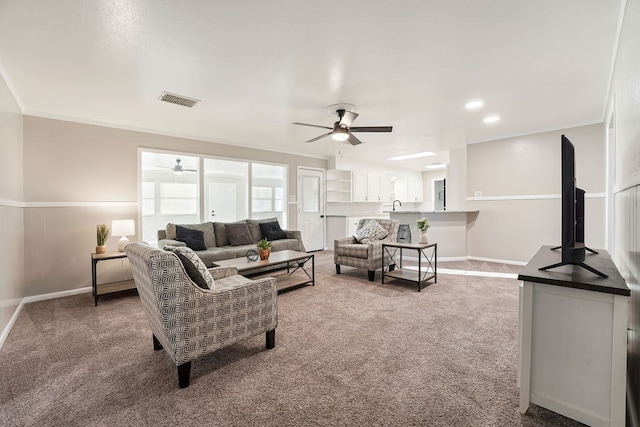 living room with carpet flooring, ceiling fan, and sink