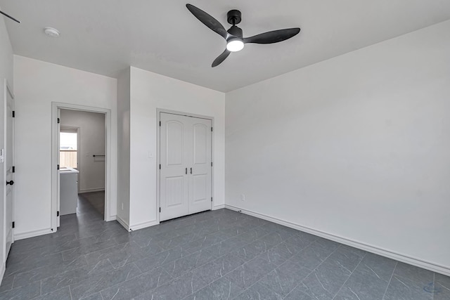 unfurnished bedroom featuring ceiling fan and a closet