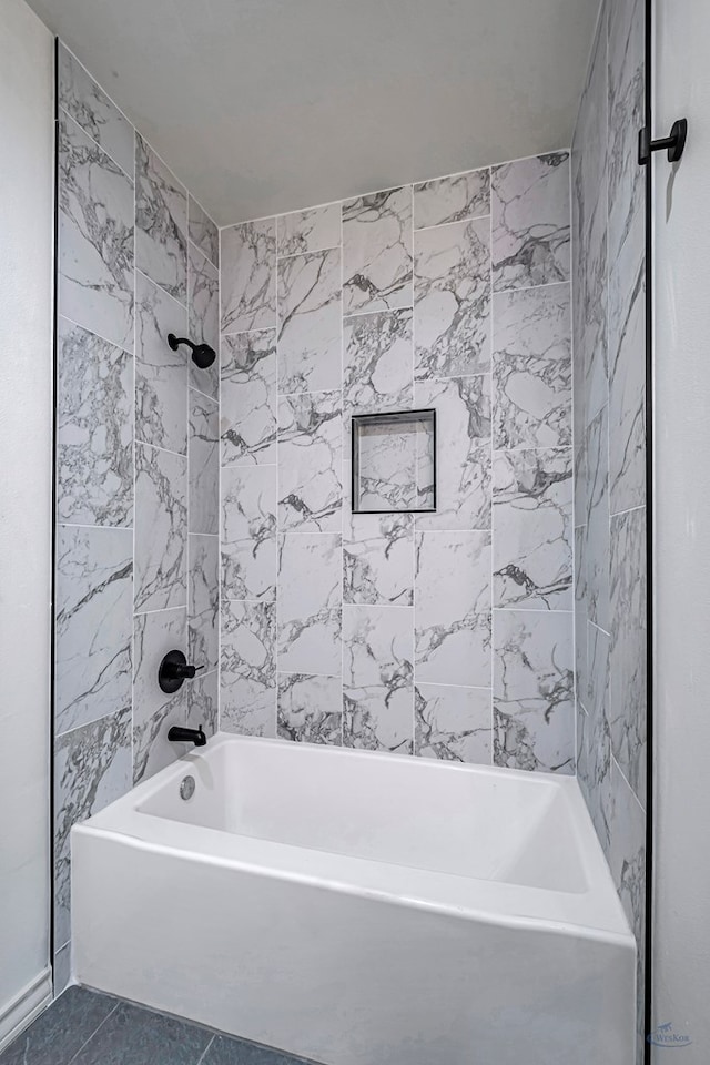 bathroom with tiled shower / bath and tile patterned flooring