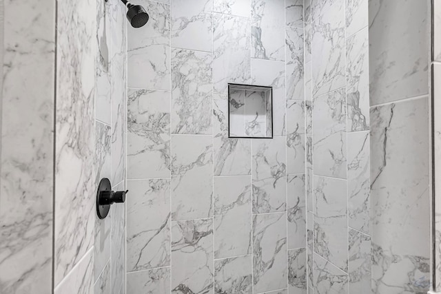 interior details with a tile shower