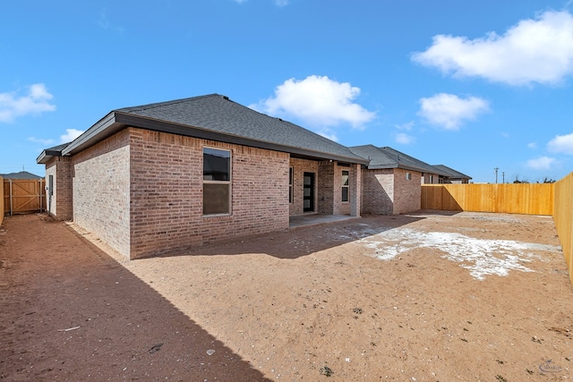 back of property with a patio