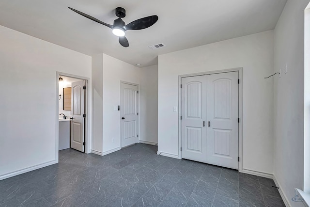 unfurnished bedroom with a closet, ceiling fan, and ensuite bathroom