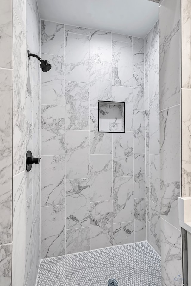 bathroom with a tile shower