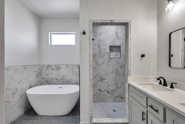 bathroom with vanity, separate shower and tub, and tile walls