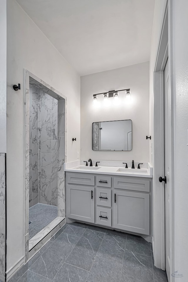 bathroom with tiled shower and vanity