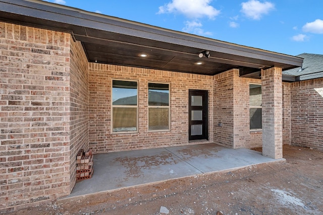 property entrance featuring a patio area