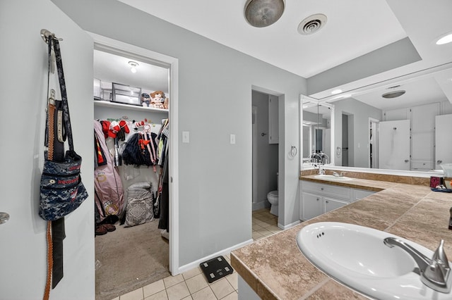 3202 Maxwell Dr, Midland, TX 79705 - full bath with double vanity, tile patterned floors, and a spacious closet