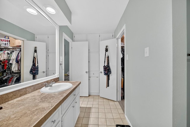 3202 Maxwell Dr, Midland, TX 79705 - bathroom with vanity, a spacious closet, and tile patterned flooring