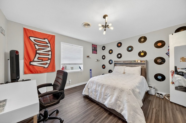 3202 Maxwell Dr, Midland, TX 79705 - bedroom featuring wood finished floors, an office area, and a chandelier