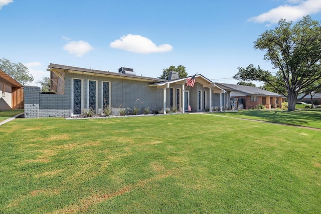 3202 Maxwell Dr, Midland, TX 79705 - view of front facade with brick siding, a front lawn, and a chimney