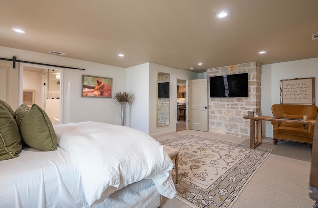 bedroom with visible vents, recessed lighting, and a barn door
