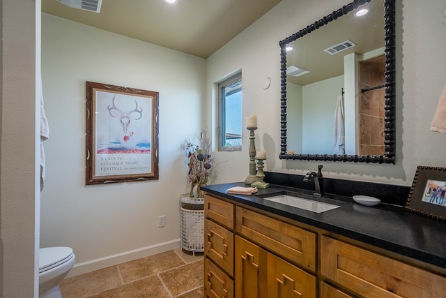 full bathroom featuring visible vents, vanity, toilet, baseboards, and stone finish flooring
