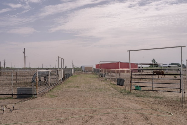 view of road with an exterior structure, a rural view, and driveway