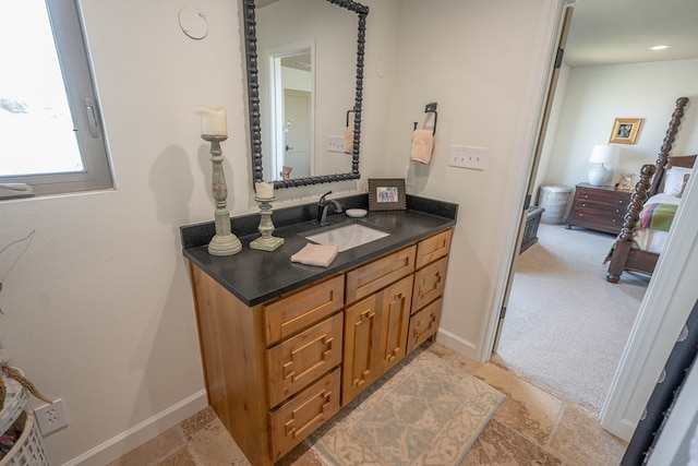 bathroom with baseboards and vanity