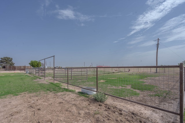 view of yard with a rural view and fence