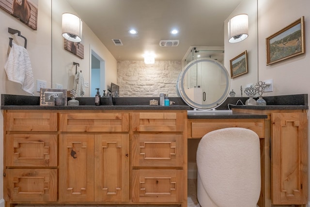 bathroom featuring double vanity, visible vents, and recessed lighting