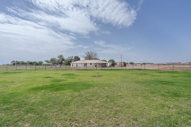 view of yard featuring fence and a rural view