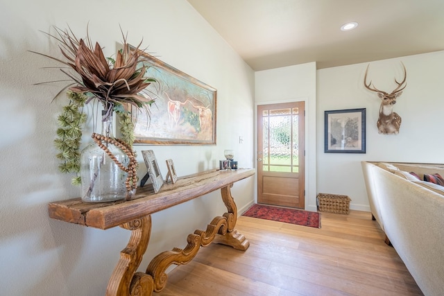 foyer with recessed lighting, baseboards, and light wood finished floors