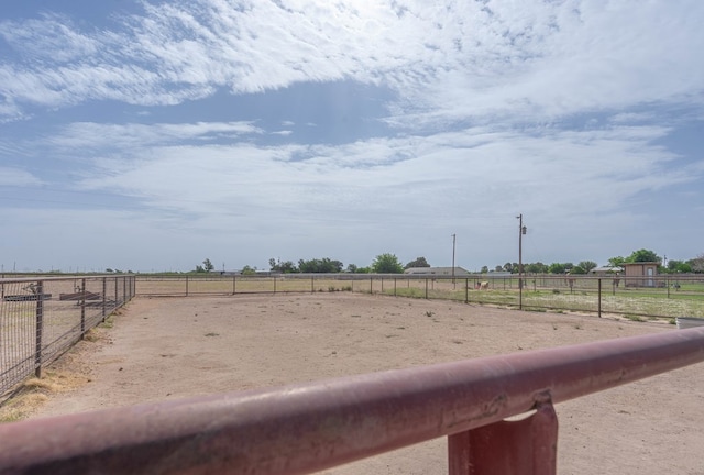 view of yard with an enclosed area and a rural view
