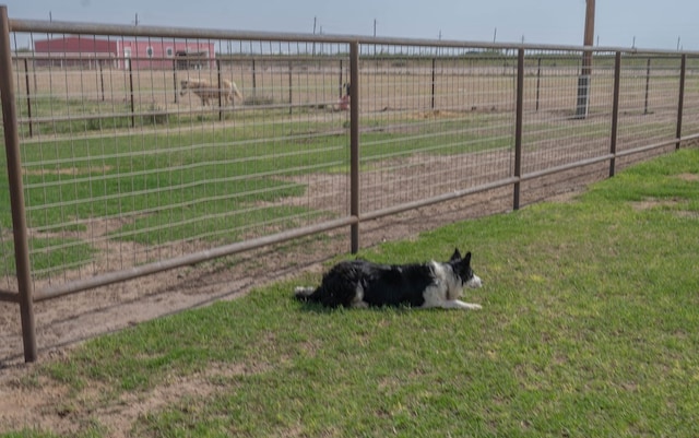 view of yard featuring a rural view and fence