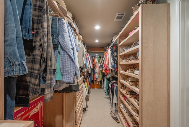 spacious closet with light colored carpet and visible vents