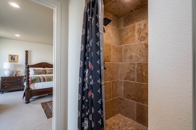 full bathroom with recessed lighting, ensuite bath, and a tile shower