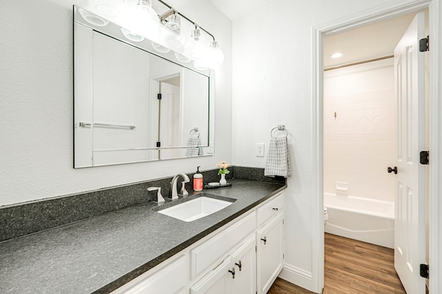 full bathroom with wood-type flooring, toilet, vanity, and shower / bathing tub combination