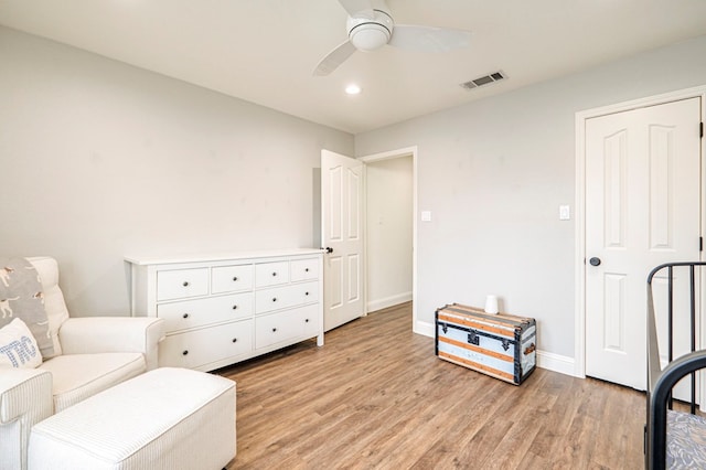 living area with ceiling fan and light wood-type flooring