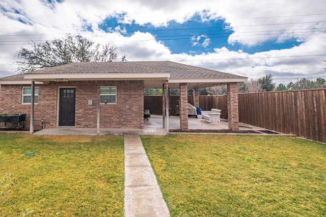 back of house with a yard and a patio area