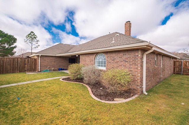 rear view of house with a lawn