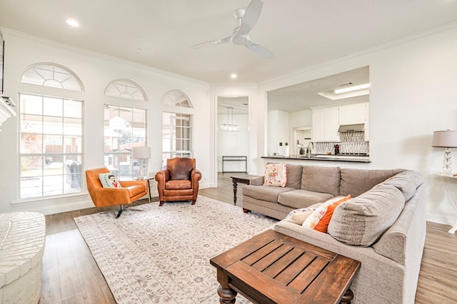 living room with ceiling fan, ornamental molding, and hardwood / wood-style floors