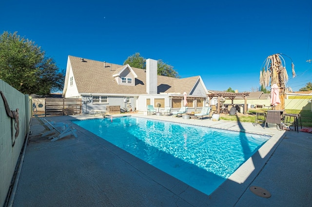 view of swimming pool with a patio and a pergola