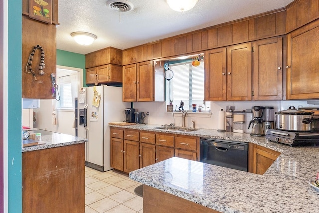 kitchen featuring sink, black dishwasher, light stone counters, a textured ceiling, and light tile patterned flooring