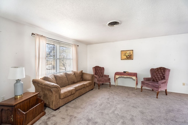 living room with a textured ceiling and light colored carpet