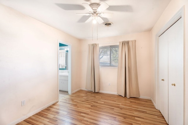 unfurnished bedroom with connected bathroom, ceiling fan, and light wood-type flooring