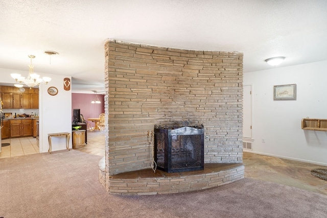 room details featuring a stone fireplace, carpet floors, and a chandelier