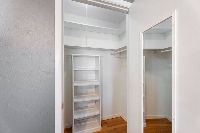 spacious closet featuring hardwood / wood-style flooring