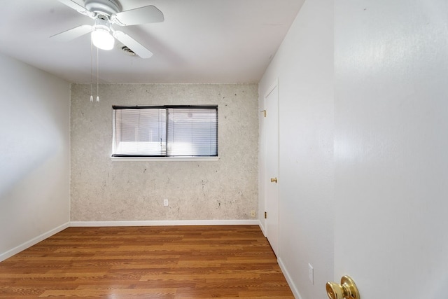 unfurnished room with ceiling fan and wood-type flooring