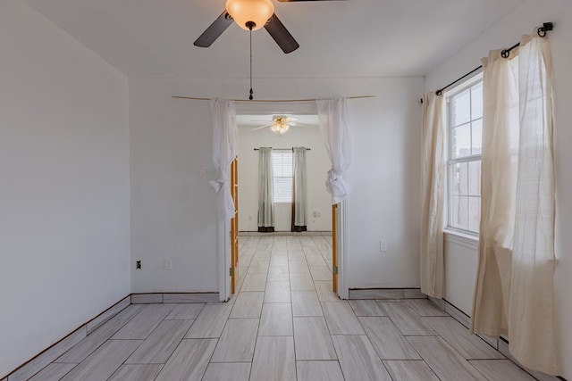 empty room with plenty of natural light and ceiling fan