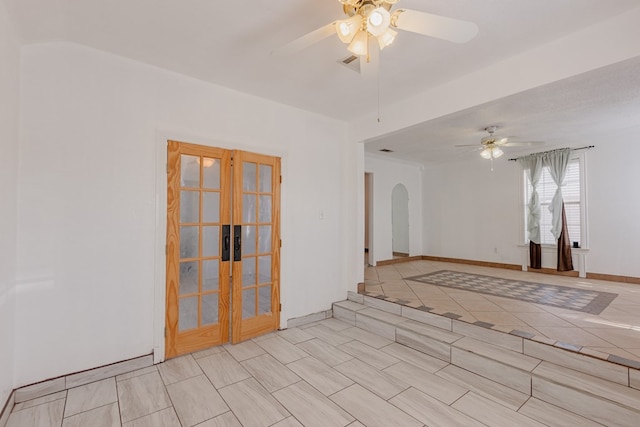 spare room with a textured ceiling, french doors, and ceiling fan