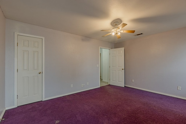 carpeted spare room featuring ceiling fan