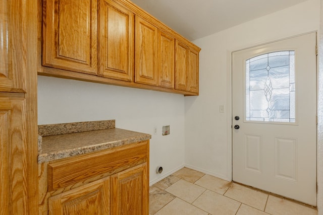 laundry area featuring hookup for a washing machine, cabinets, and light tile patterned flooring