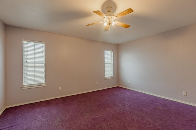 carpeted spare room featuring ceiling fan and a healthy amount of sunlight