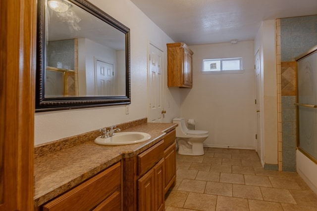 full bathroom with vanity, combined bath / shower with glass door, and toilet