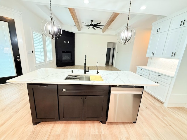 kitchen featuring light hardwood / wood-style floors, beam ceiling, white cabinetry, and sink